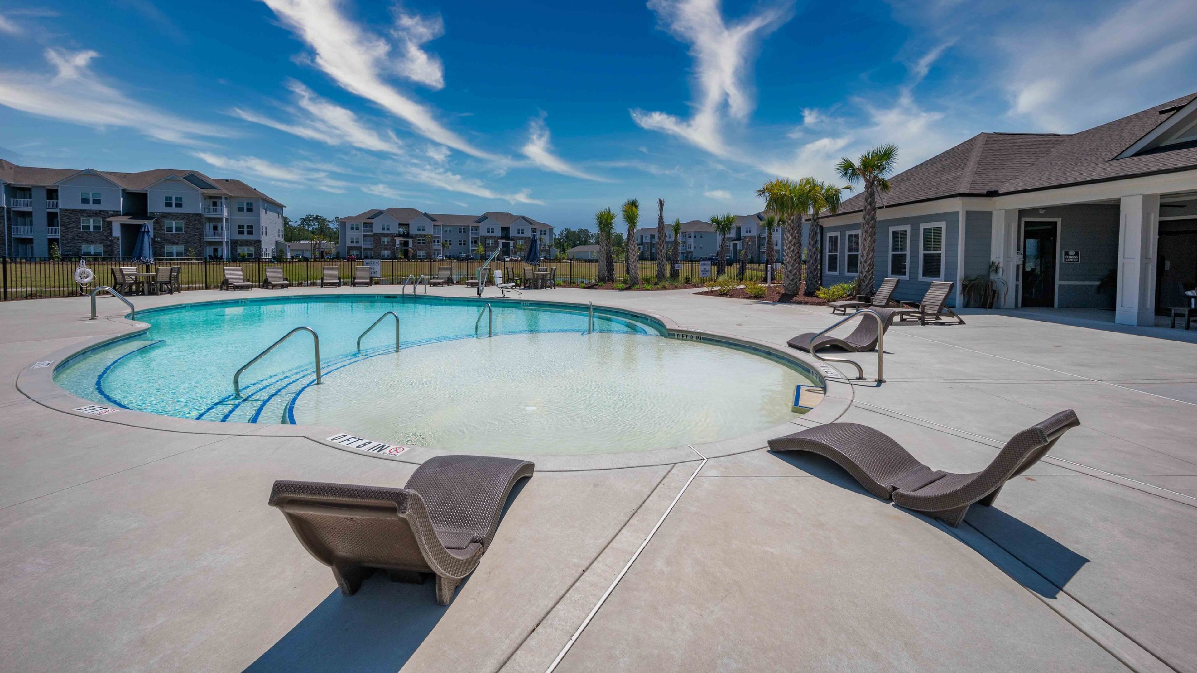 Hawthorne at the Bend uxury outdoor pool with in-pool lounge chairs and surrounding seating