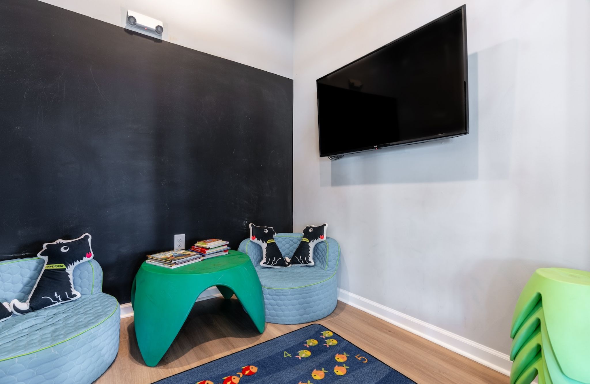 Hawthorne at the Bend indoor kids lounge and playroom with seating and tv