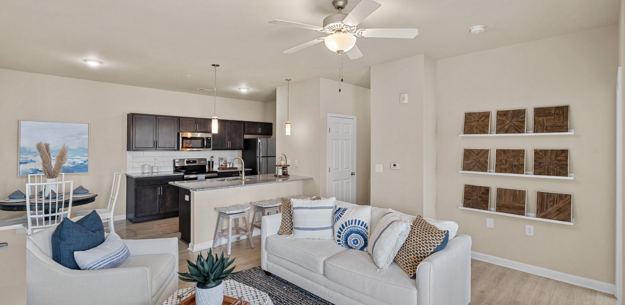 Hawthorne at the Bend apartment living room with large patio doors, furnished with a couch, coffee table, and chair