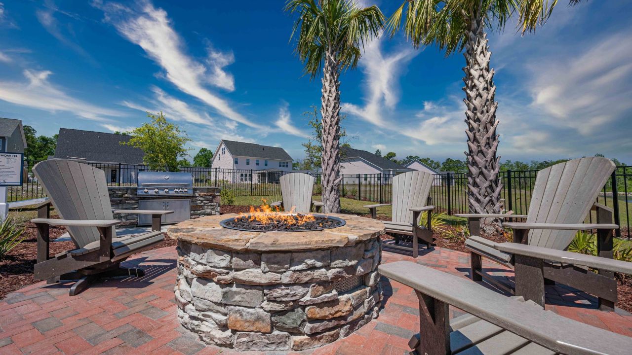Hawthorne at the Bend outdoor fire pit with Adirondack chairs and grills