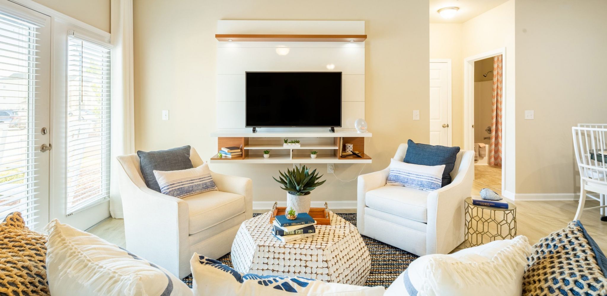 Hawthorne at the Bend apartment living room with large patio doors, furnished with a couch, coffee table, and chair