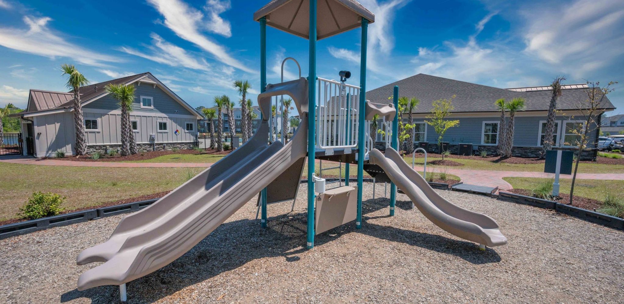 Hawthorne at the Bend outdoor playground space with surrounding greenery